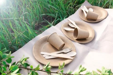 Sets of disposable biodegradable tableware on craft paper in nature Stock Photos