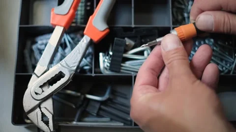 Sets of tools and the hands of the master who is engaged in repair. 動画素材 243632923