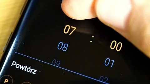 Setting an alarm clock on a modern smartphone, 7:00, 7 AM, detail, closeup Stock Footage 143402886
