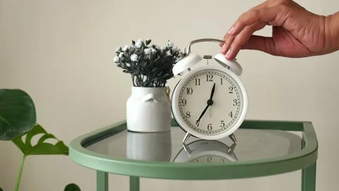 Setting the alarm clock for the morning routine Stock Footage 330093062