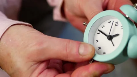 Setting an alarm clock time close up shot Stock Footage 206125478