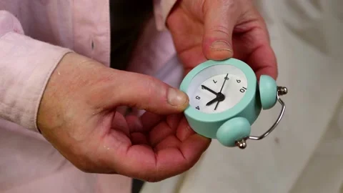 Setting an alarm clock time medium shot selective focus Stock Footage 200155285