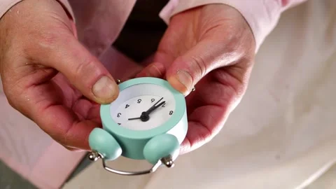 Setting an alarm clock time medium shot selective focus Stock Footage 201488091