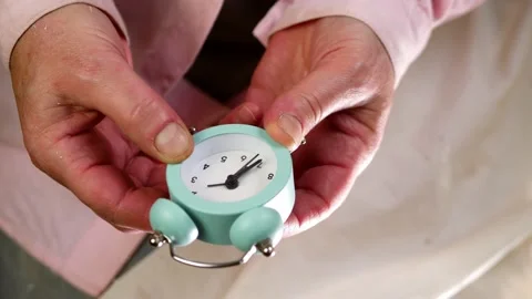 Setting an alarm clock time medium shot selective focus Stock Footage 209964672