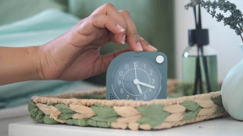 Setting the alarm on a modern clock at home Stock Footage 326577010