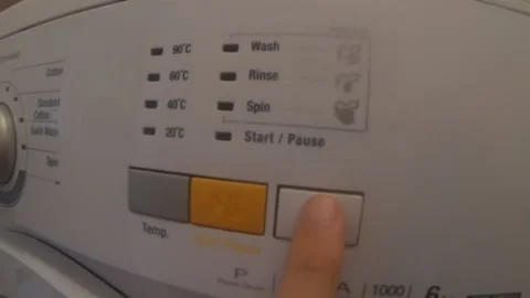 Setting Up and Starting a Washing Machine in the Kitchen Stock Footage