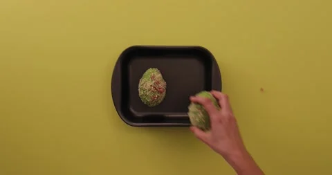 Setting avocado in a pan and picking it up 2 Stock Footage 132136625