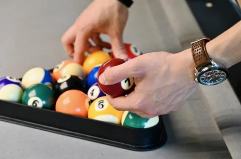 Setting up billiard balls with a triangle rack on a pool table Stock Photos
