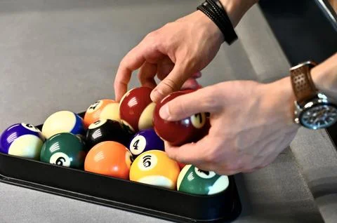 Setting up billiard balls with a triangle rack on a pool table 写真素材