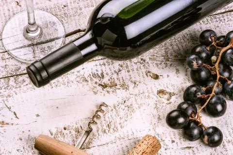Setting with bottle of red wine, grape and corks Stock Photos