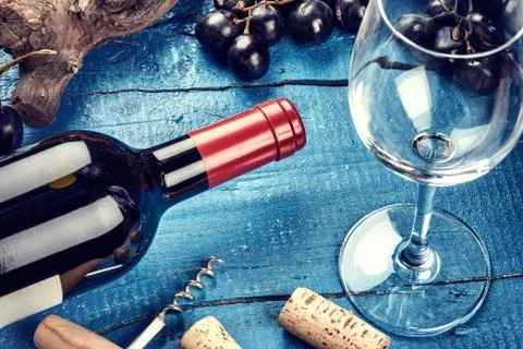Setting with bottle of red wine, grape and corks. Wine list concept Stock Photos