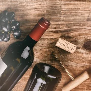 Setting with bottle of red wine, grape and corks. Wine list concept Stock Photos