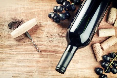 Setting with bottle of red wine, grape and corks. Wine list concept Stock Photos