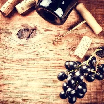 Setting with bottle of red wine, grape and corks. Wine list concept Stock Photos