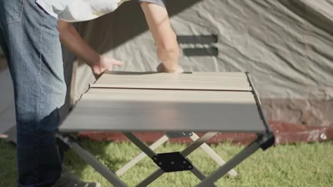 Setting Up a Camping Table in a Backyard Stockbeeldmateriaal 346534136