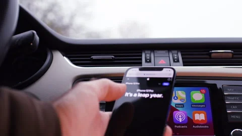 Setting Up CarPlay on iPhone Pro in Car Stock Footage 276603510