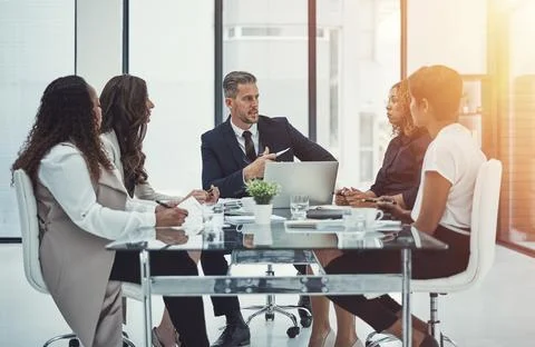 Setting clear objectives for the project. a group of colleagues having a meeting Stock Photos