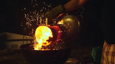 Setting up the coals for a night barbecue Stock Footage 79615582