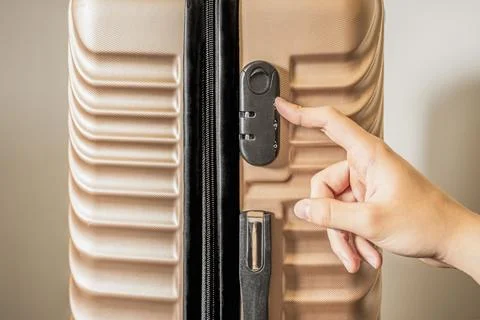 Setting a combination code lock on a suitcase for safe travel Stock Photos