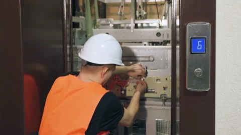Setting up complex modern elevator equipment, engineer adjusts elevator parts. A Video stock 266229450