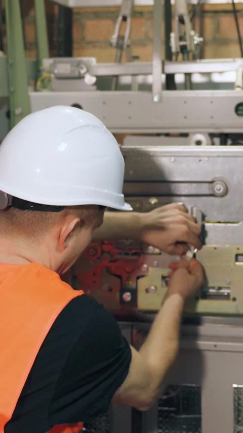 Setting up complex modern elevator equipment, engineer adjusts elevator parts. A Video stock 300877630