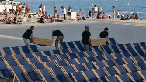 Setting up deck chairs for Cinéma de la Plage, Cannes beach Stock Footage 320745277