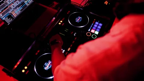 Setting up digital mixing console with hands of DJ Stock Footage 251975703