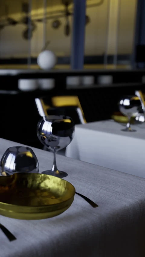 Setting a dining table with glassware and gold bowl in modern restaurant Stock Footage 332208115