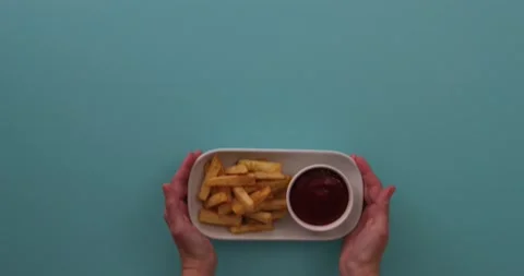 Setting down a plate of fries 1 Stock Footage 132194081