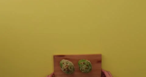 Setting down a tray of avocados Stock Footage 132136743