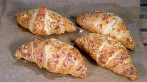 Setting down a tray of freshly baked croissants. Stock Footage 155536444