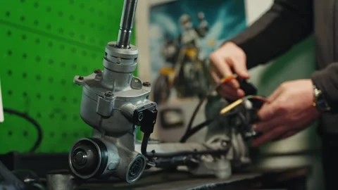 Setting up the electronic steering rack of a car, the master connects the Stock Footage 284545514