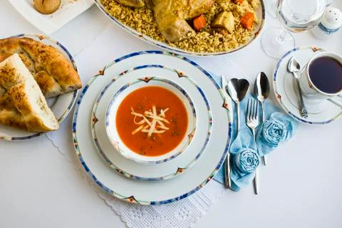 Setting Fasting Ramadan Table with tomato soup and sliced Ramadan Bread Stock Photos