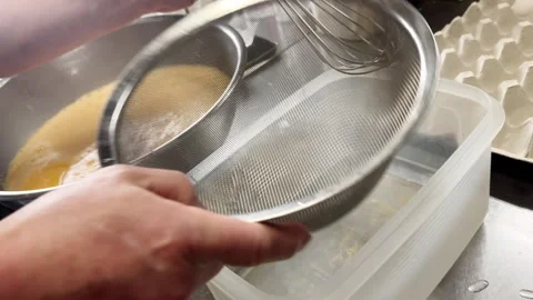 Setting a Fine Strainer to Sieve Beaten Eggs for Japanese Dashimaki, Japan Stock Footage 340752188