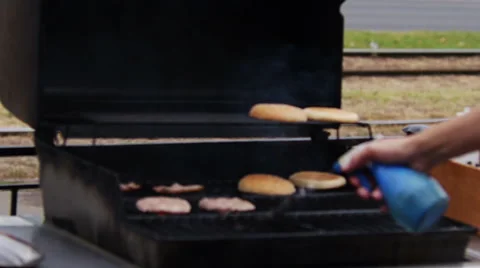 Setting Fire to the Grill for Frying Raw Meat and buns for Burgers Video stock 62655497