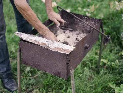 Setting fire in a handmade grill 写真素材