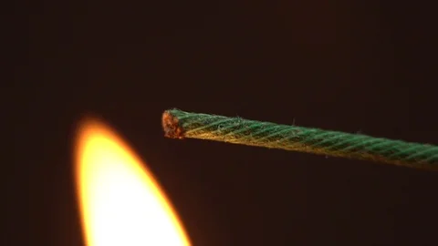 Setting fire to wick of the bomb dynamite or petard in slow motion Stock Footage 108985622