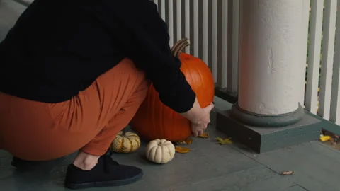 Setting the Halloween Pumpkin Jack-O'-Lantern On the Porch Slow Motion 4K Stock Footage 308196964