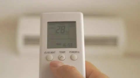 Setting lower temperature on air conditioner remote control 4K 3840X2160 Stock Footage 52185121