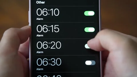 Setting many alarms on mobile phone to be woken up in the morning Stock Footage 338041477