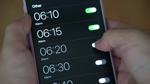 Setting many alarms on mobile phone to be woken up in the morning Stock Footage 338041478