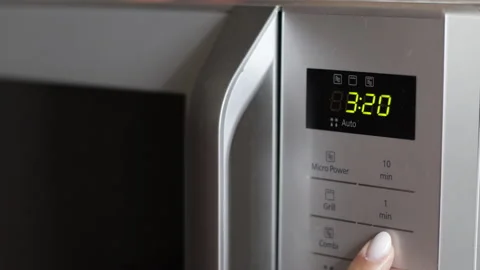 Setting up microwave for cooking. Closeup view Stock Footage 200928969