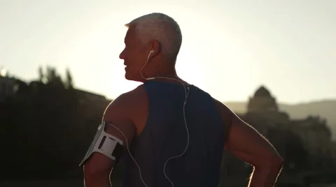 Setting music and route on phone before jogging Stock Footage