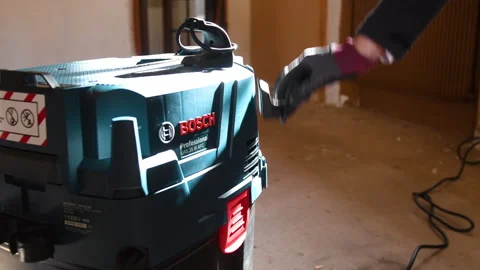 Setting Up New Bosch Vacuum in Workshop Stock Footage 303868148