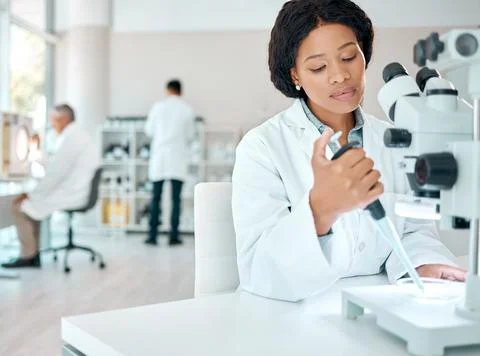 Setting up for a new experiment. a young scientist working with samples while Stock Photos