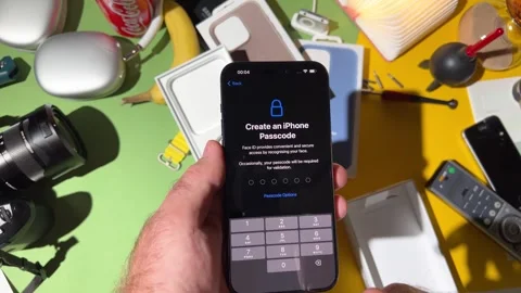 Setting Up New Titanium Apple iPhone 15 Pro in Creative Workspace Stock-Footage 251889972