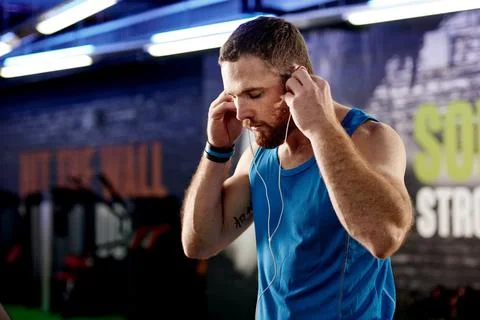 Setting the pace with his playlist. a young man listening to music during his Stock Photos