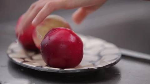Setting peaches on a dish Stock Footage 62226470