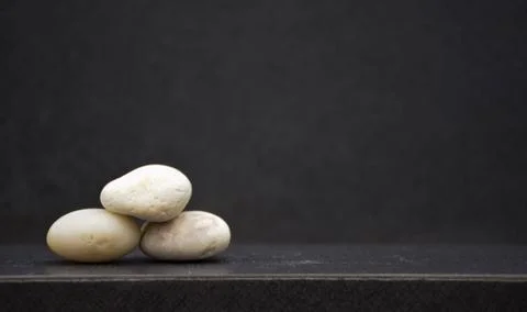 Setting pyramid stone on table with copy space and blur background for creati Stock Photos