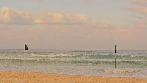 Setting restrictive flags on the beach Stock Footage 119336997